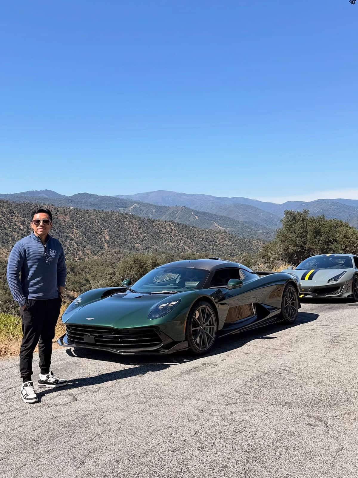 Dark green hypercar on a canyon road above Monterey